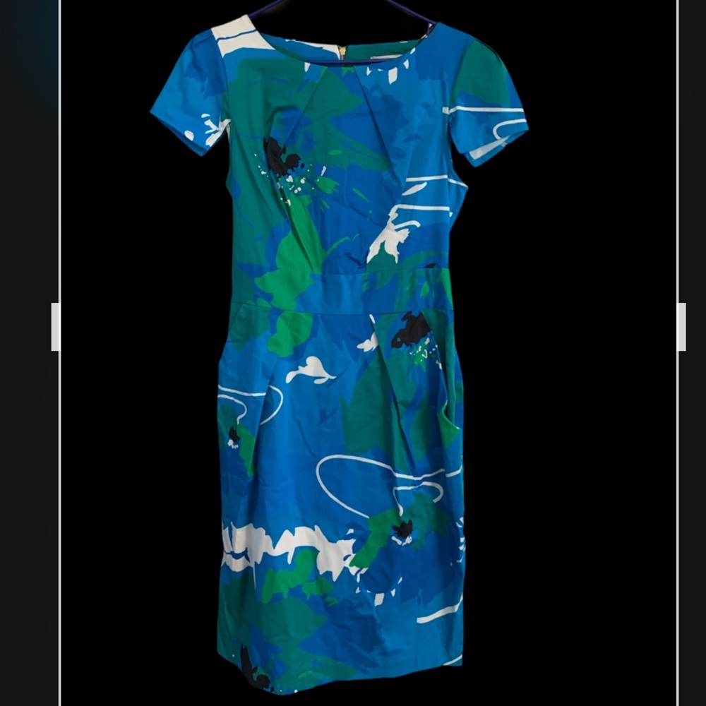 Structured dress with pleats and front pockets